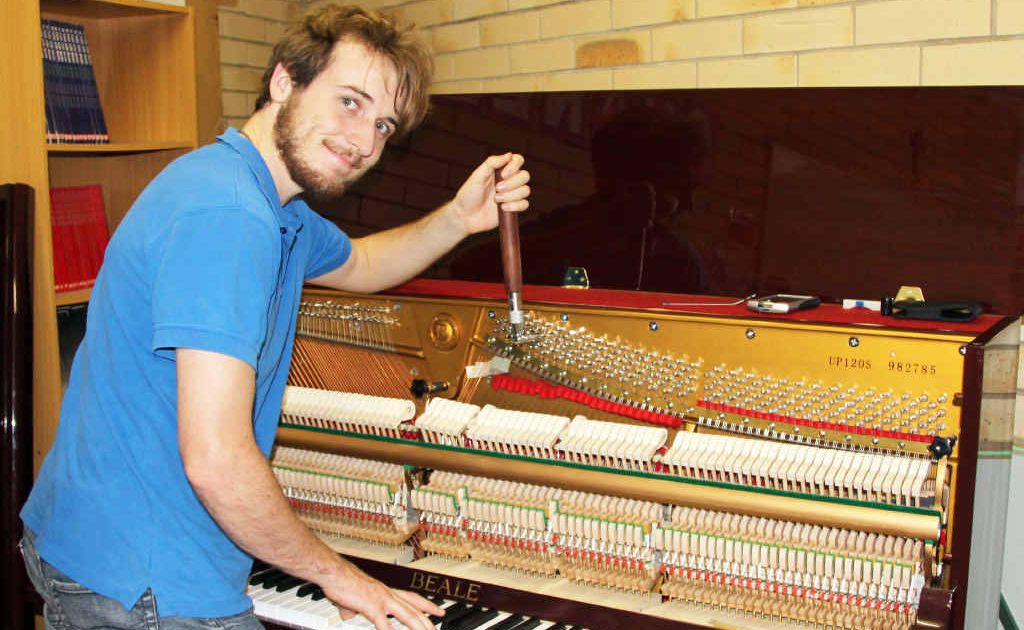 Ben Fraser tunes a piano at the Emerald Marist College. Ben Fraser tunes a piano at the Emerald Marist College.